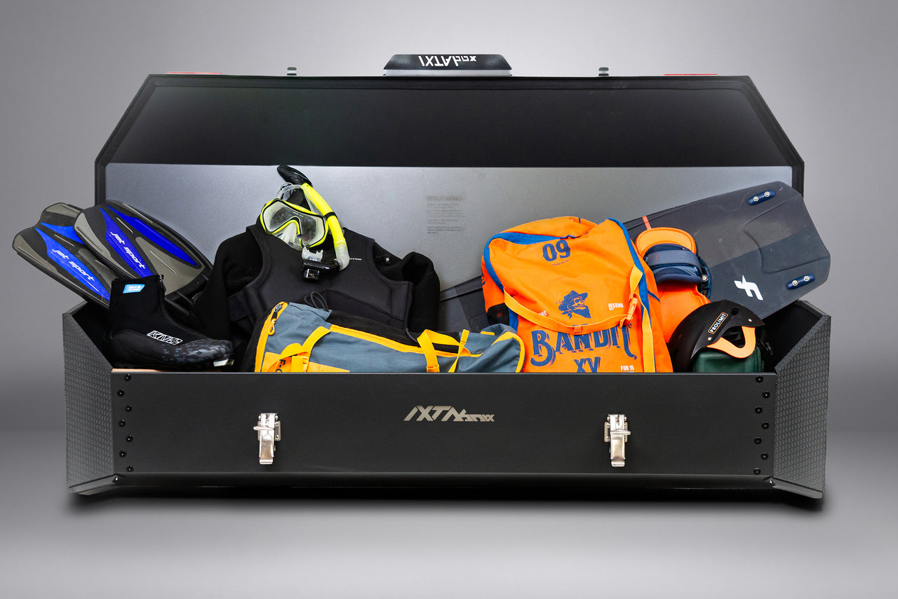IXTAbox Classic cargo box loaded with water sports equipment, showing full storage capacity in real-world use